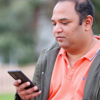 Person using smartphone to research mental health topics