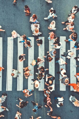 Aerial. Big crowd of people. People gathered together in one place. Top view from drone. Image with flare effect.