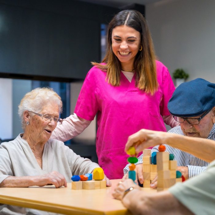 Nurse and elder people playing skill games in a nursing home