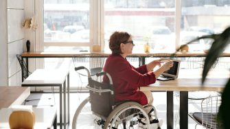 Woman in wheelchair at laptop