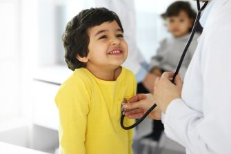 Doctor examining a child patient by stethoscope