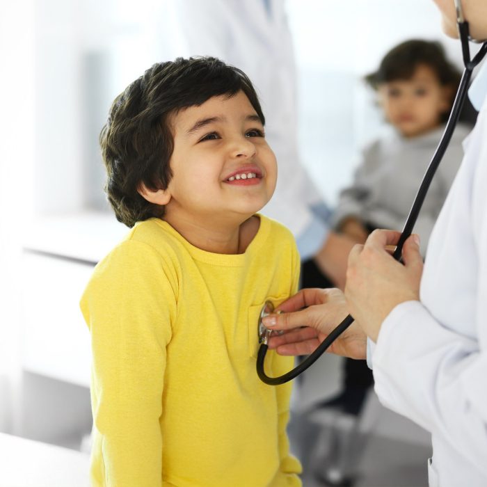 Doctor examining a child patient by stethoscope