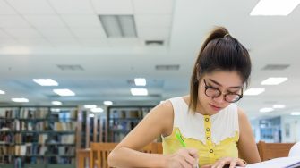 study education, woman writing on a paper, working women