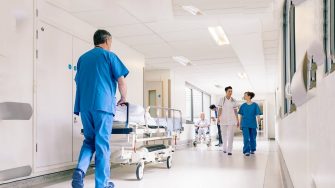 Doctors Hospital Corridor Nurse Pushing Gurney Stretcher Bed