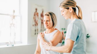 Modern rehabilitation physiotherapy worker with woman client