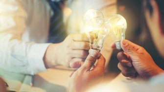 Sharing idea for help concept, Colleagues sharing a light bulb of idea