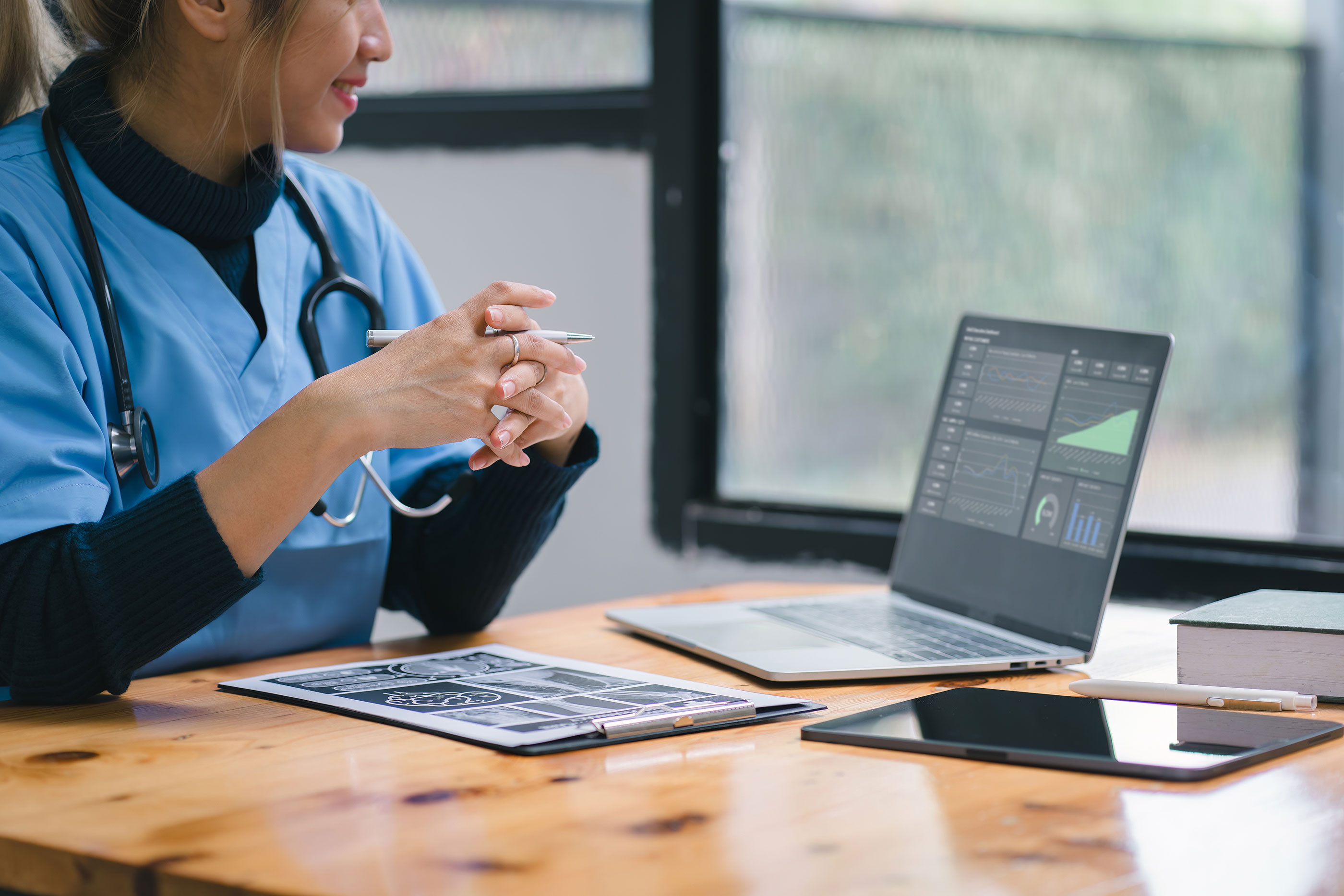 A doctor looks at a computer screen