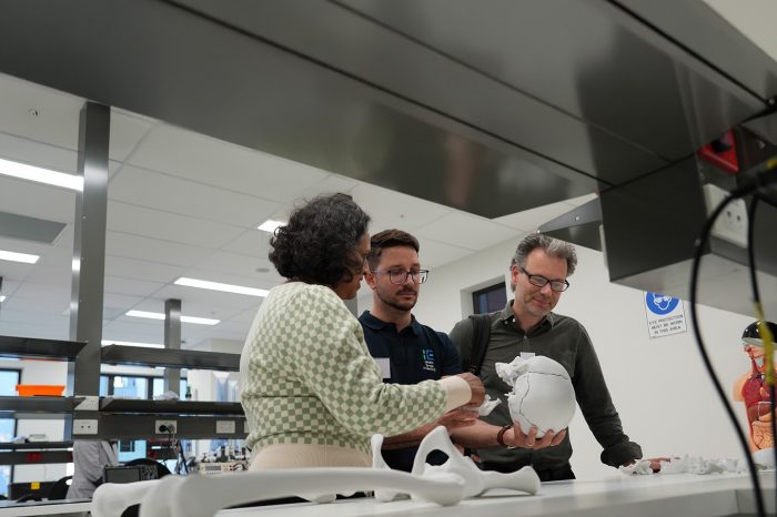 a group people holding a skull mock and talking