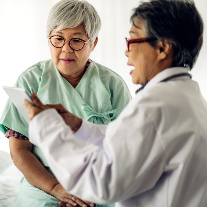 Female senior doctor consulting and examining senior woman patient with stethoscope in hospital.healthcare and medicine