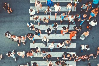 People crossing busy intersection
