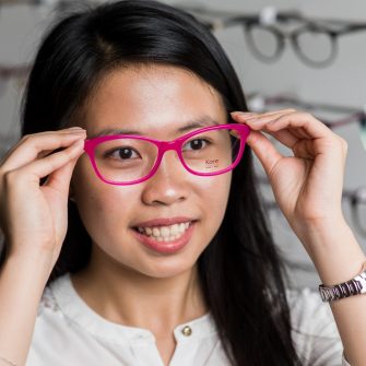 Portrate of science student holding a pair of glasses