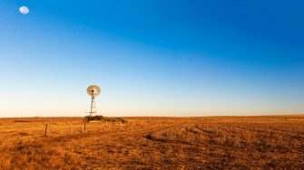 Panoramic view of early morning landscape with a windmill.