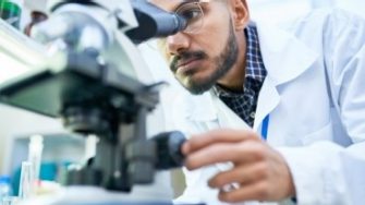 Scientist using microscope in laboratory