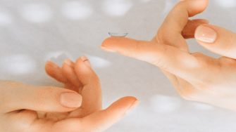 Hands with contact lens