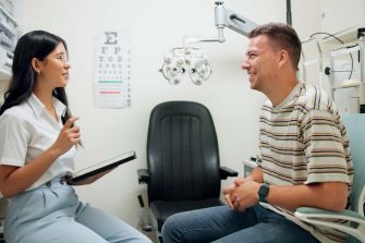 Optometry, tablet and woman with patient in clinic for medical service, consulting and eye exam. Healthcare, optician and optometrist on digital tech with man for vision, wellness and online results