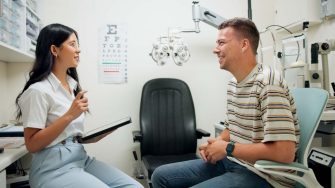 Optometry, tablet and woman with patient in clinic for medical service, consulting and eye exam. Healthcare, optician and optometrist on digital tech with man for vision, wellness and online results