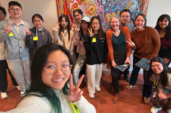 Students from HUST tour with Katrina Blazek post for a group photo