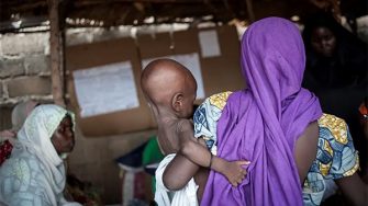 A picture taken on June 30, 2016 shows a mother holding her young baby suffering from severe acute malnutrition during an inspection at one of the Unicef nutrition clinics in the Muna informal settlement, which houses nearly 16,000 IDPs (internally displaced people) in the outskirts of Maiduguri capital of Borno State, northeastern Nigeria.