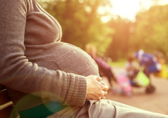Pregnant woman sitting on bench
