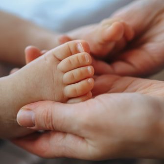 hands holding newborn feet