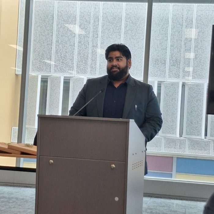 Student graduate speaks at a podium