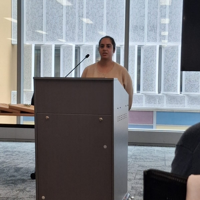 Student graduate speaks at a podium