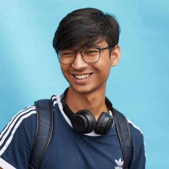 Happy student on coloured background