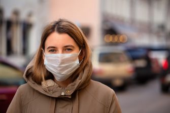 Woman wearing a face mask and jacket