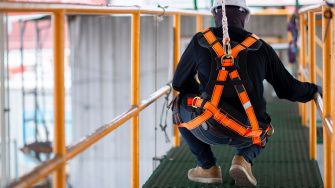 Photo of construction worker wearing safety harness.