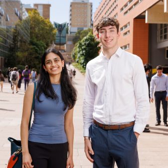 Two students standing in the UNSW main walk