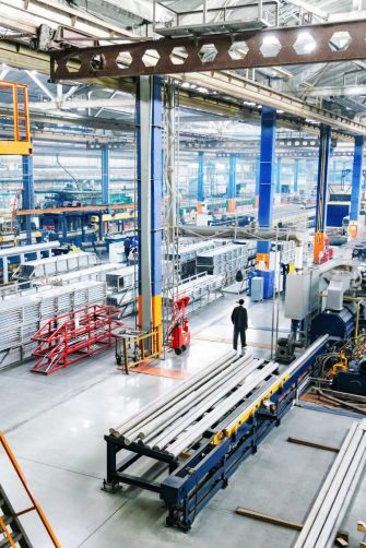 Man holding tablet looking at a digital twin model