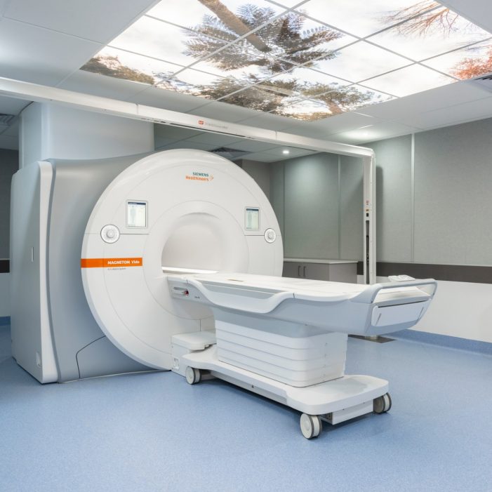 Large bore mri siemens magnetom vida in situ showing work station, patient platform, magnet, with large colourful screen on the ceiling