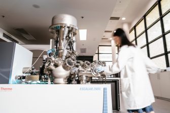 Staff member operating ESCALAB 240Xi in surface analaysis lab