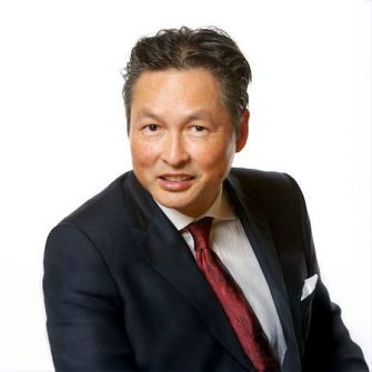 Portrait of a middle-aged east Asian man in a navy suit with a red tie