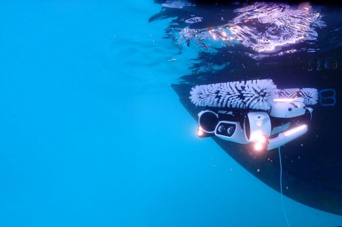 Hullbot h6 underwater drone scrubbing the hull of a boat