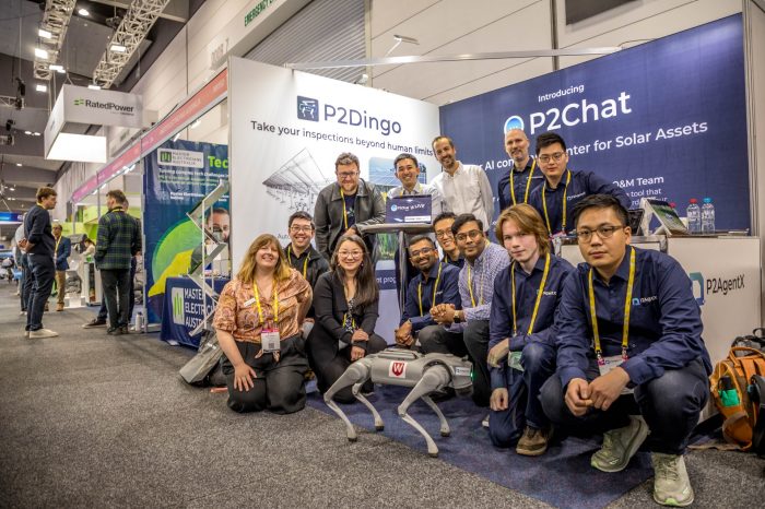 P2AgentX team standing with their Dingo robot at a trade show