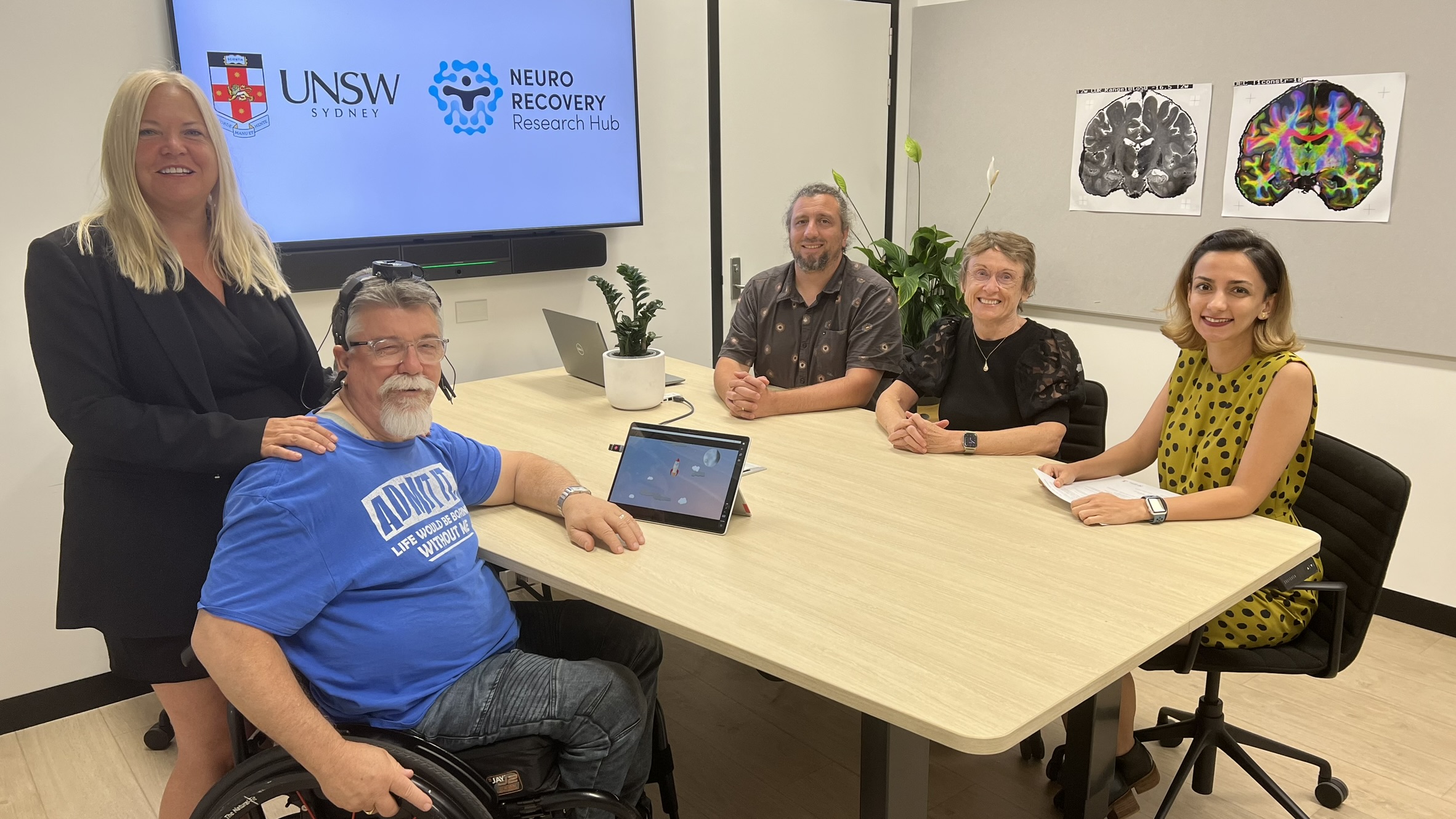 The UNSW/NeuRA team who developed PainWaive sitting around a table