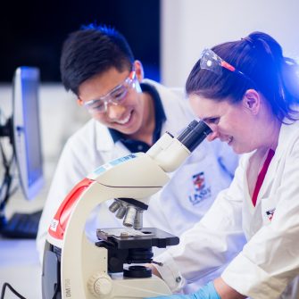 Photograph of students using microscope