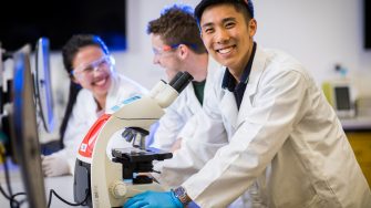 Photograph of students using microscope