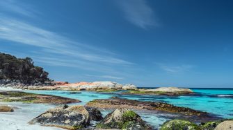 Rocky shoreline under a blue sky