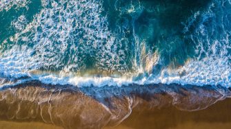 Aerial image of surf and sand at Royal National Park