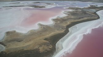 Drying inland salt lake pink water salt patches