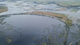 Aerial photo of floodplain being inundated with water from  flooded lakes