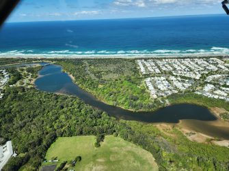 Aerial image of of town and estuary and ocean in background
