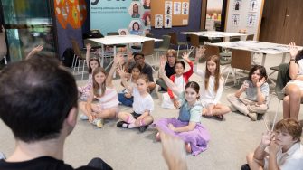 A photo of children smiling at the camera with the words 'Future You' on a teal backdrop behind them.