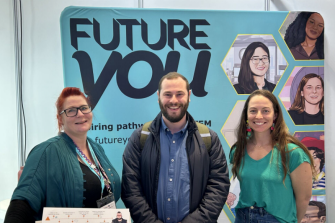A photo of three people smiling at the camera with the words 'Future You' on a teal backdrop behind them.