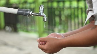 Person washing their hands at a tap