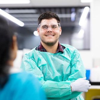 Male student in green labcoat