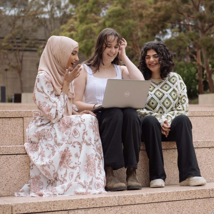 A group of student looking at the camera and smiling.