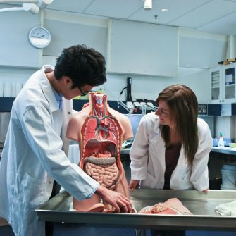 An image of two students in an anatomy class